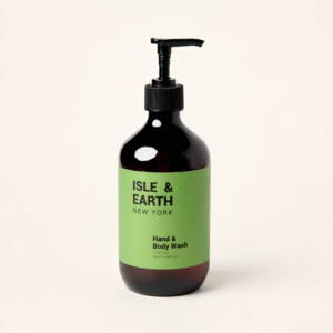 Isle & Earth Ginger Smoky Cardamom Hand & Body Wash amber pump bottle with green label on cream background
