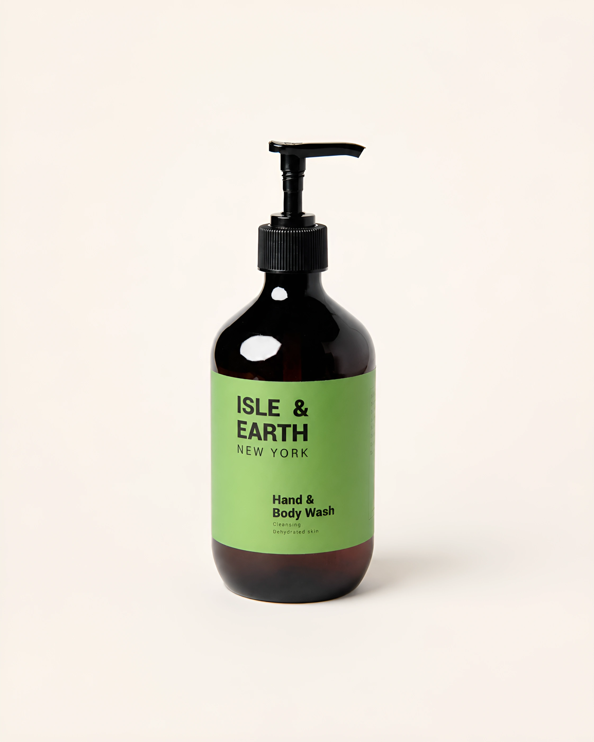 Isle & Earth Ginger Smoky Cardamom Hand & Body Wash amber pump bottle with green label on cream background